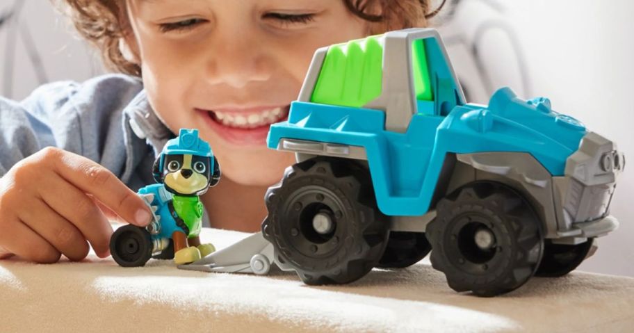 kid playing with Paw Patrol Rex's Dinosaur Rescue Vehicle