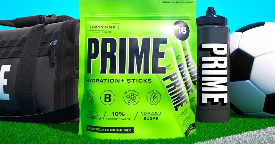 green bag of Prime Hydration+ Sticks in Lemon Lime flavor on field near soccer gear