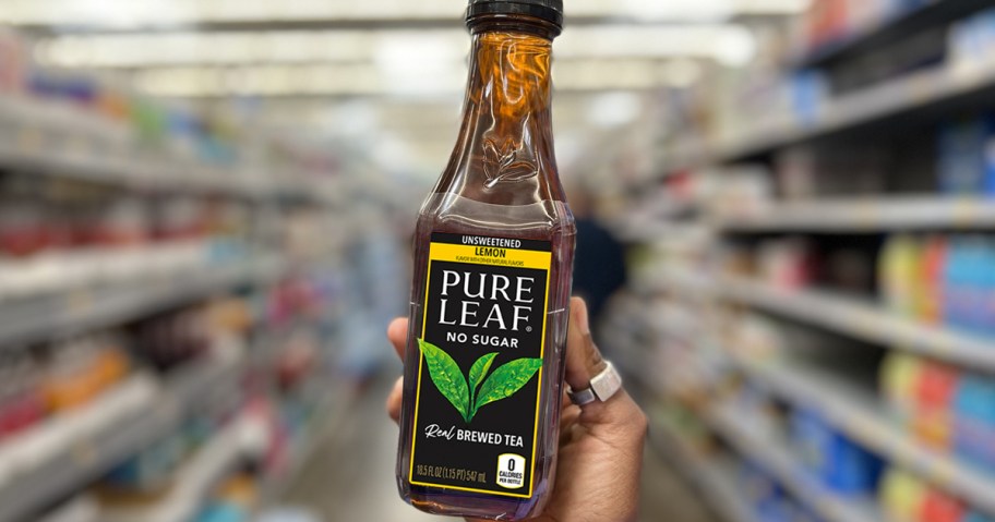 hand holding up a bottle of Pure Leaf Tea in store