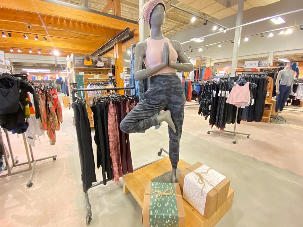 mannequin in front of women's clothing section in REI store