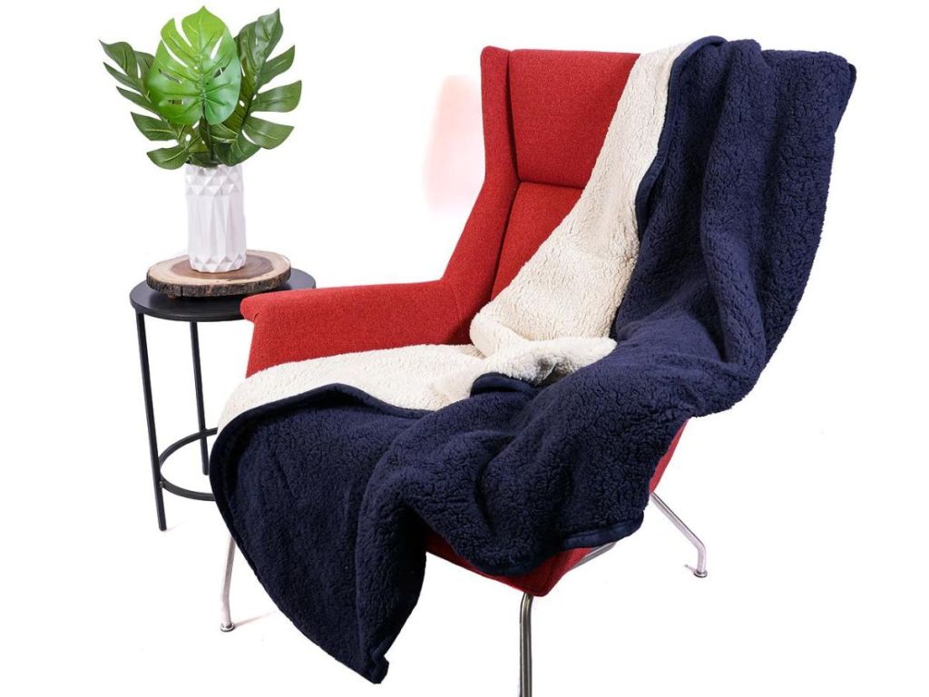 blue and white sherpa throw blanket thrown over red chair
