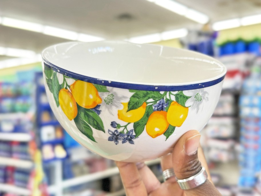 hand holding up a lemon printed cereal bowl in store