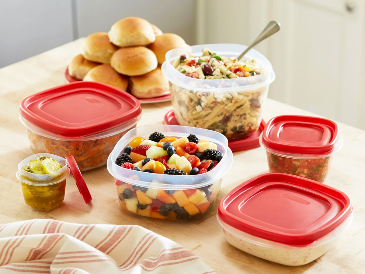 food storage container set with red lids filled with food on kitchen counter