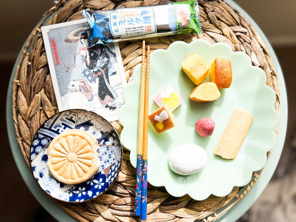Japanese snacks on plates with chopsticks