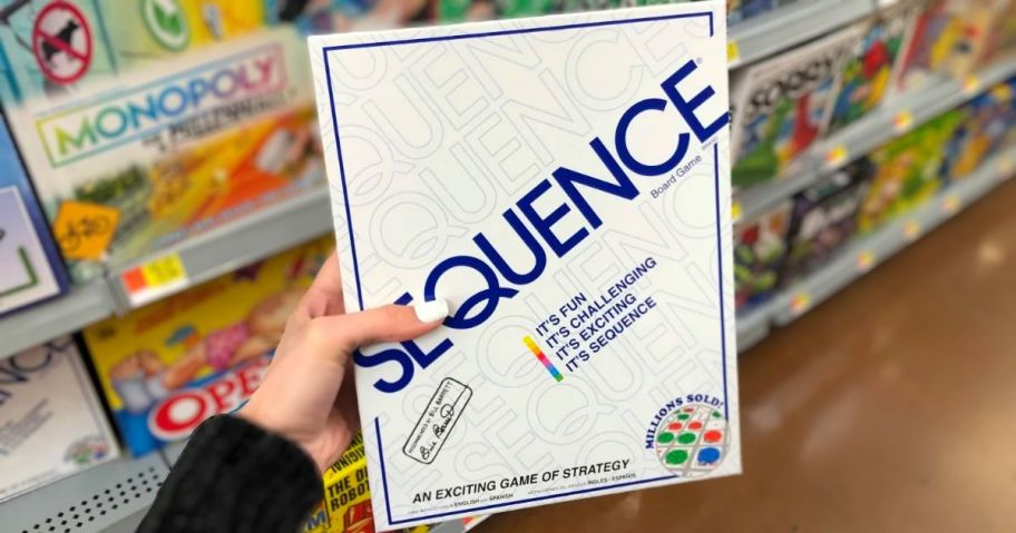 a womans had displaying the Sequence game box in a store