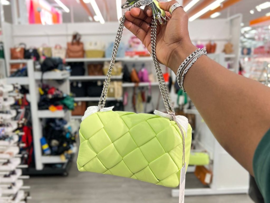 a womans hand displaying A New Day Sophie crossbody bag in lime