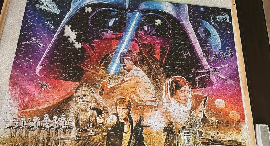 Star wars puzzle with pieces around it