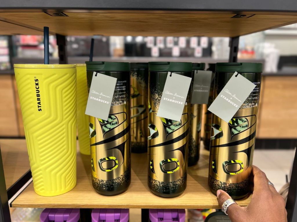 Starbucks Yellow and Black and Gold tumblers on shelf at Target