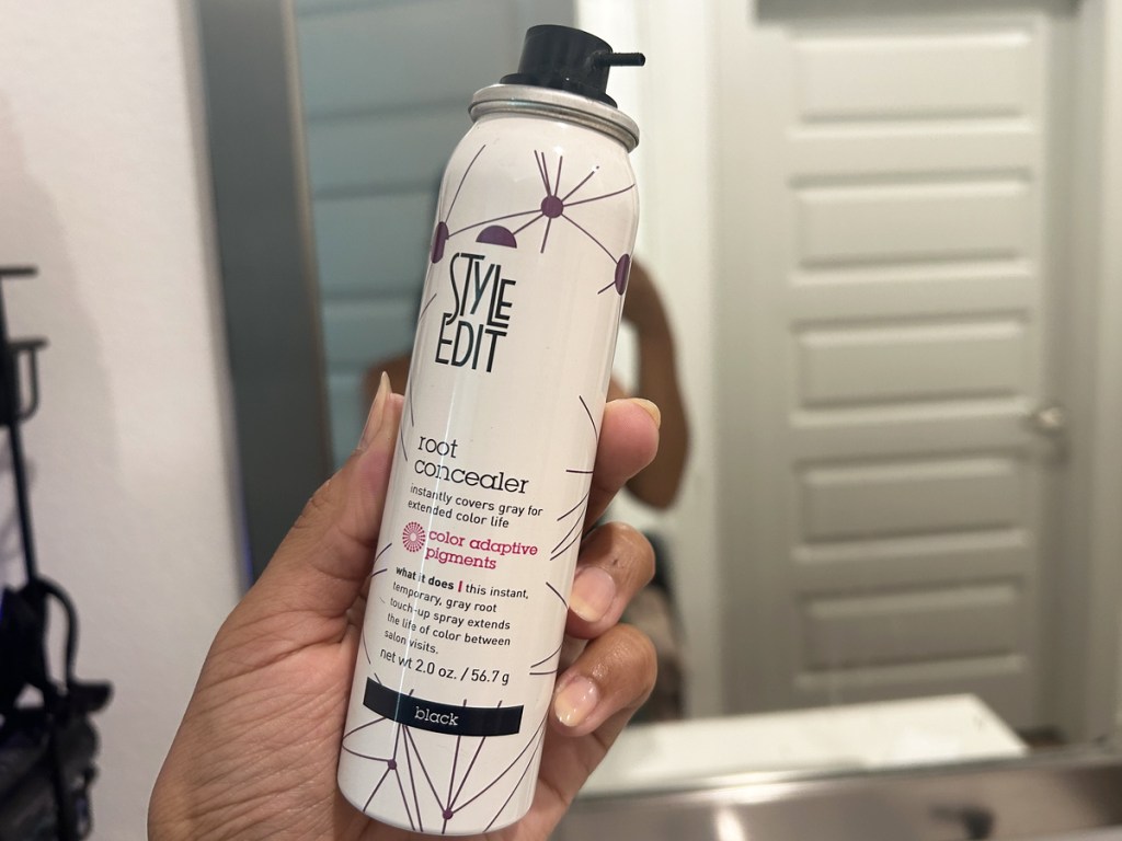 hand holding up a can of Style Edit Root Concealer Touch-Up Spray
