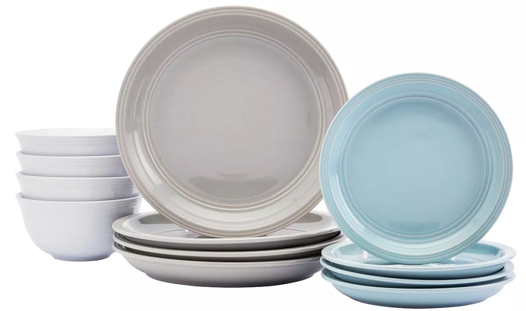 stacks of white bowls, grey dinner plates, and blue salad plates
