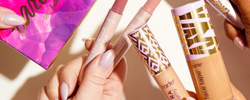 multiple hands holding tarte shape tapel lip products, and eyeshadow palette