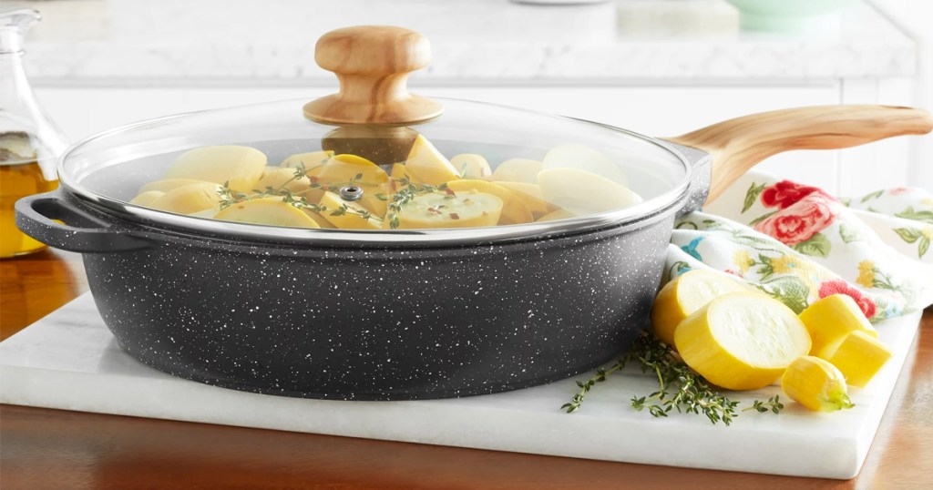 black speckled jumbo cooker pan with yellow zucchini inside