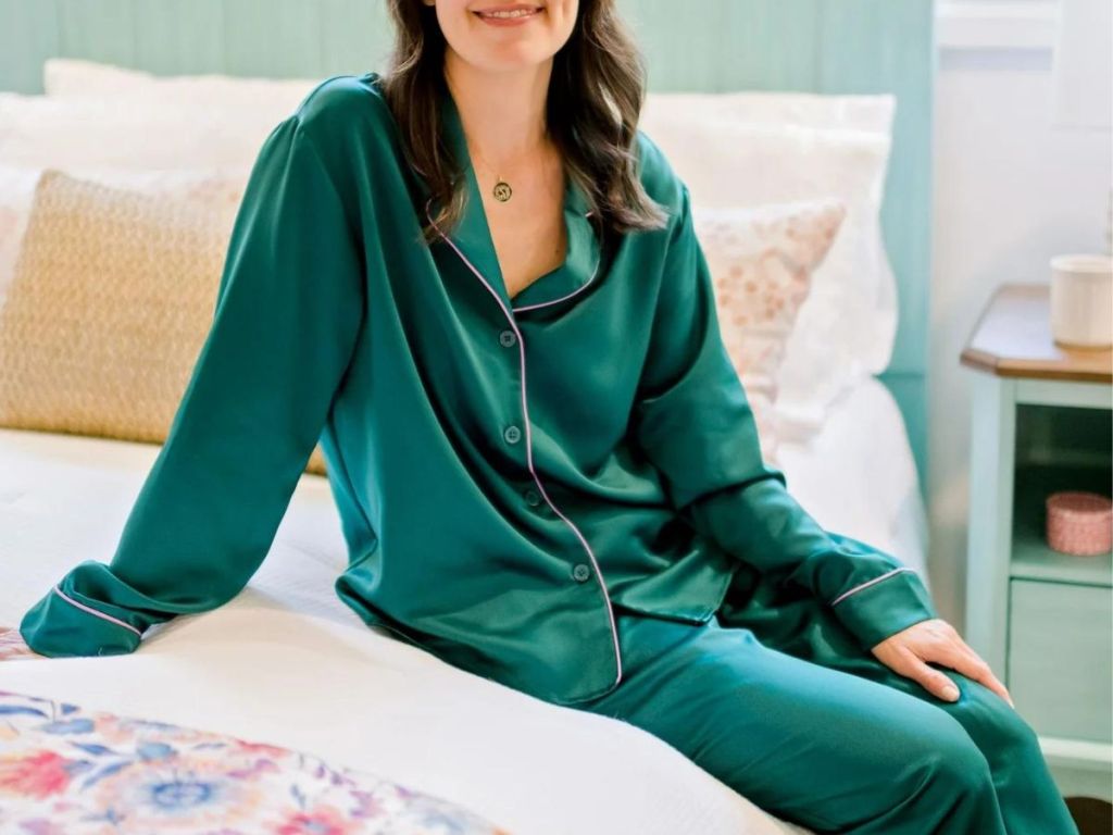 woman wearing The Pinoeer Woman Satin pajamas while sitting on a bed