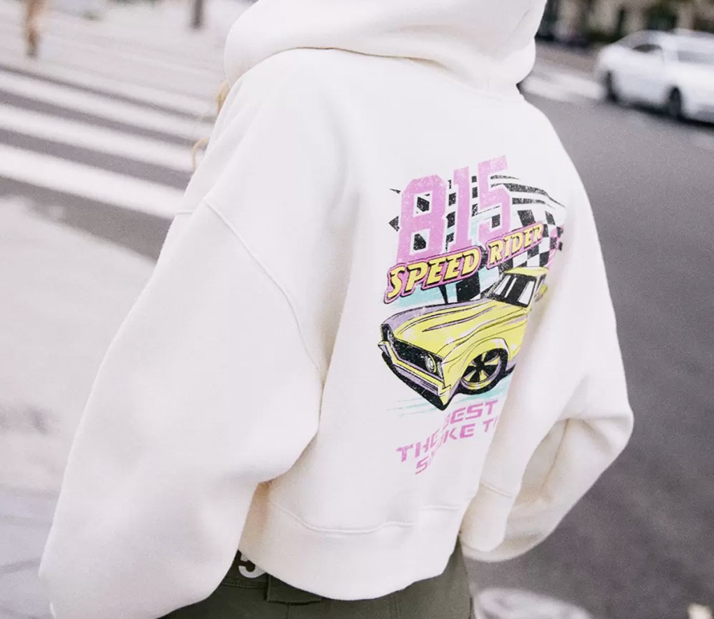 woman wearing white hoodie with race car graphic on back