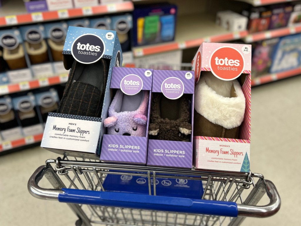 Four different pairs of totes slippers inside Walgreens shopping cart