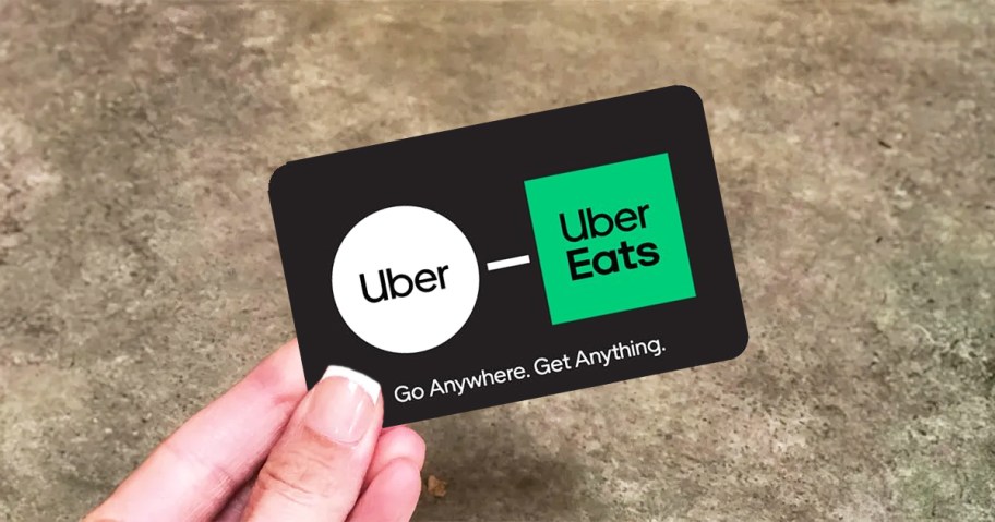 hand holding up an uber/uber eats gift card