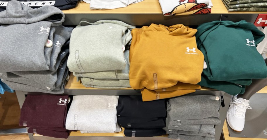 folded under armour hoodies on store display table
