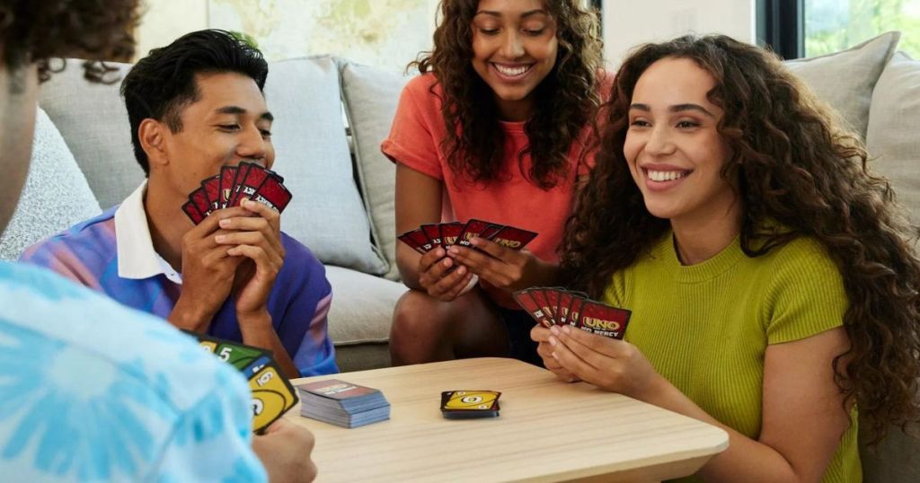 People smiling while playing UNO Show 'Em No Mercy 