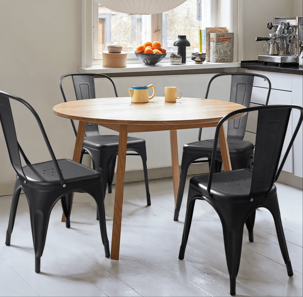 A table with 4 Lilian Slat Stackable Chairs from Wayfair
