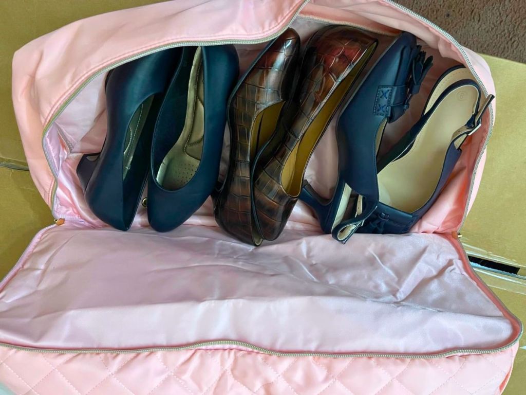 Wedama Large Weekender Duffle Bag shoe compartment shown with 3 pair of womens shoes stashed inside