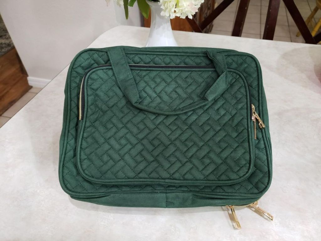 A green Wedama Toiletry Bag on a table