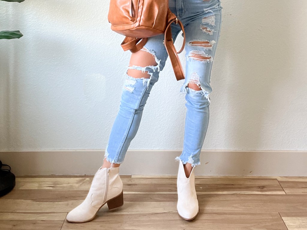 Woman in white ankle boots & jeans