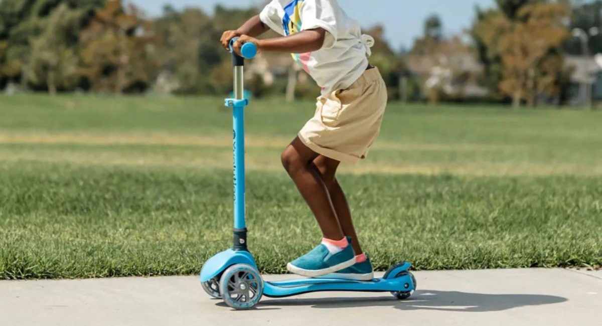 A child riding a blue Yvolution Scooter