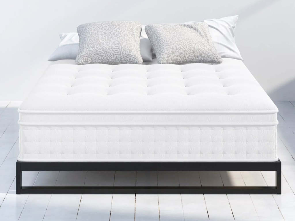 white mattress on a black metal bed frame