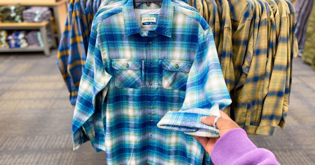 rack of plaid shirts in store