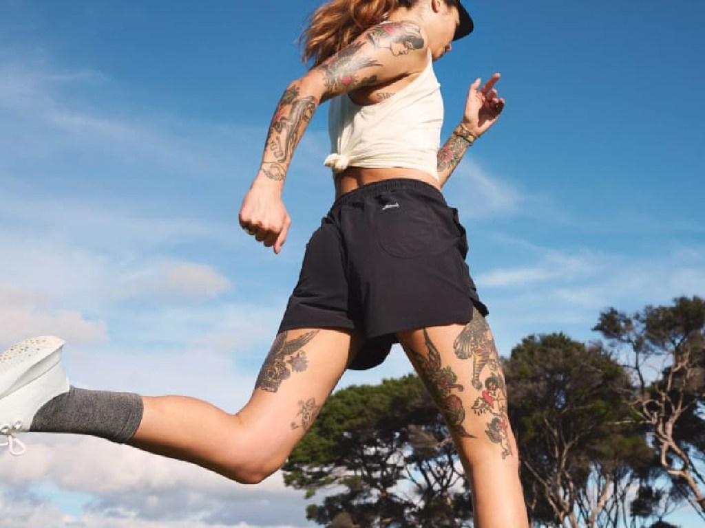 woman running in allbirds shorts