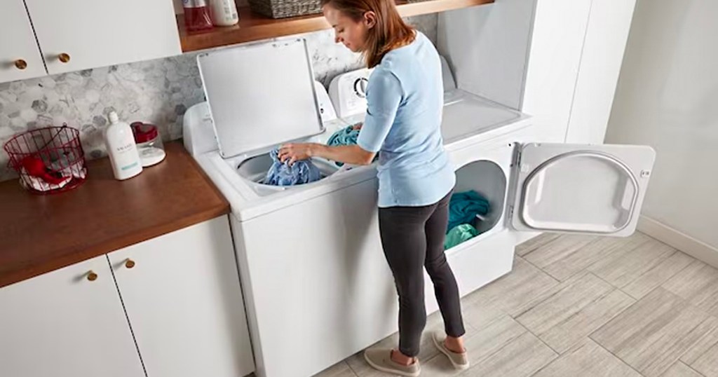 woman loading amana washer with clothes