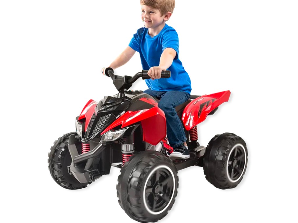 boy riding red atv ride on toy