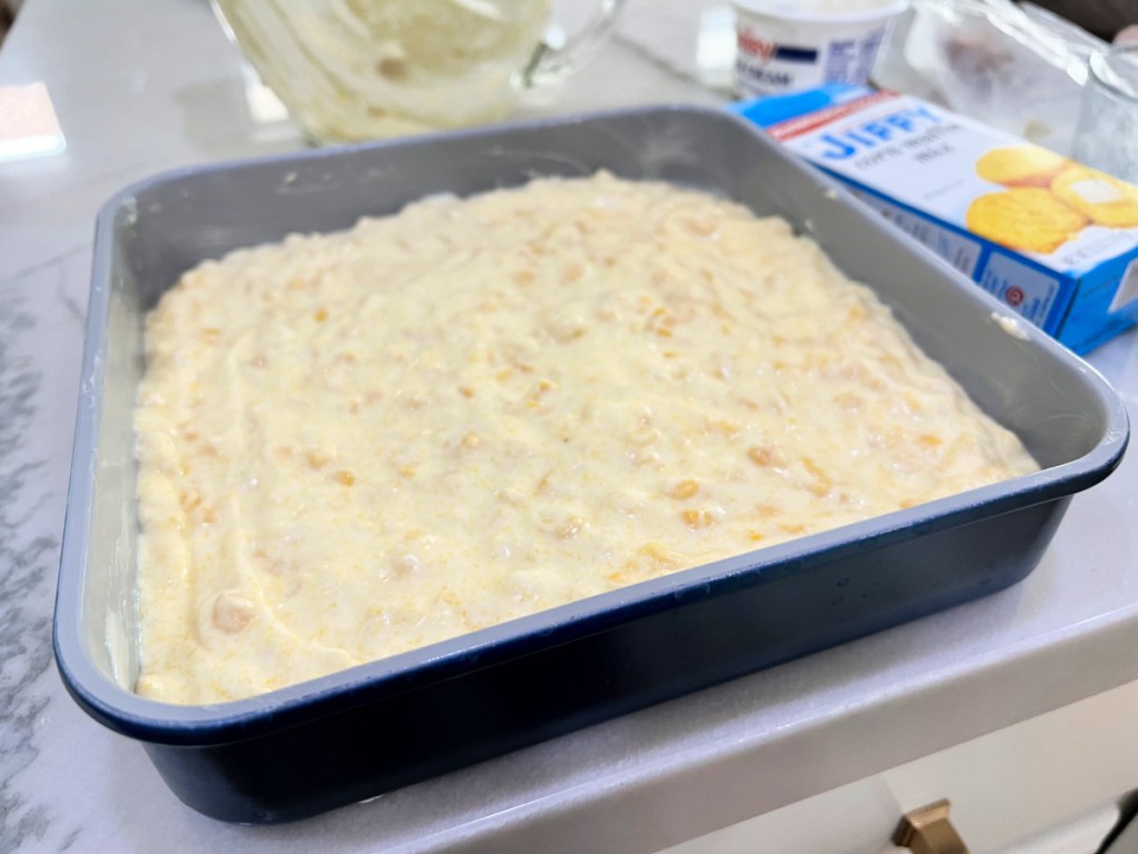 baking dish with corn casserole batter inside