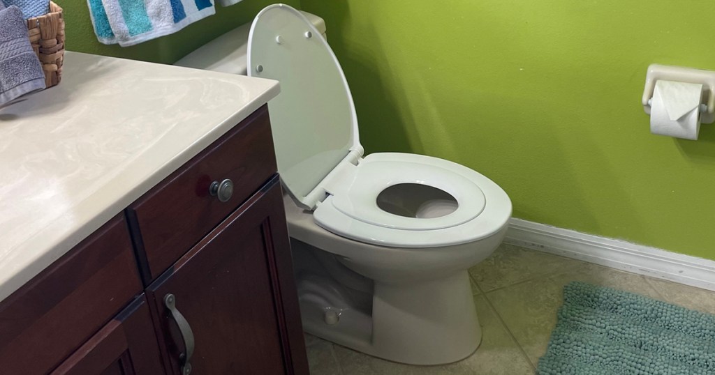 elongated toilet seat with toddler seat in bathroom