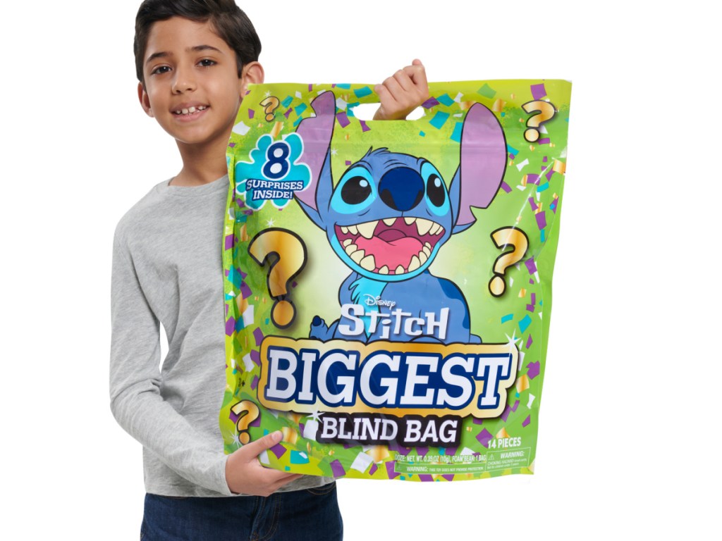 boy holding up a Stitch biggest blind bag