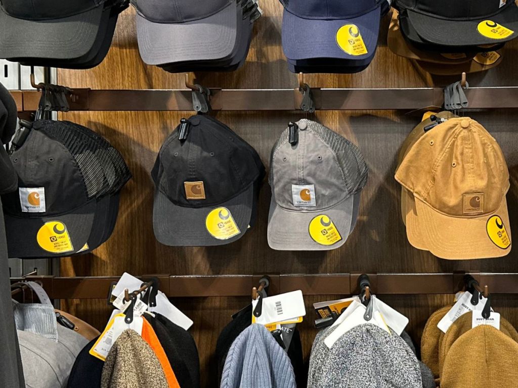 various Carhartt hats hanging in store