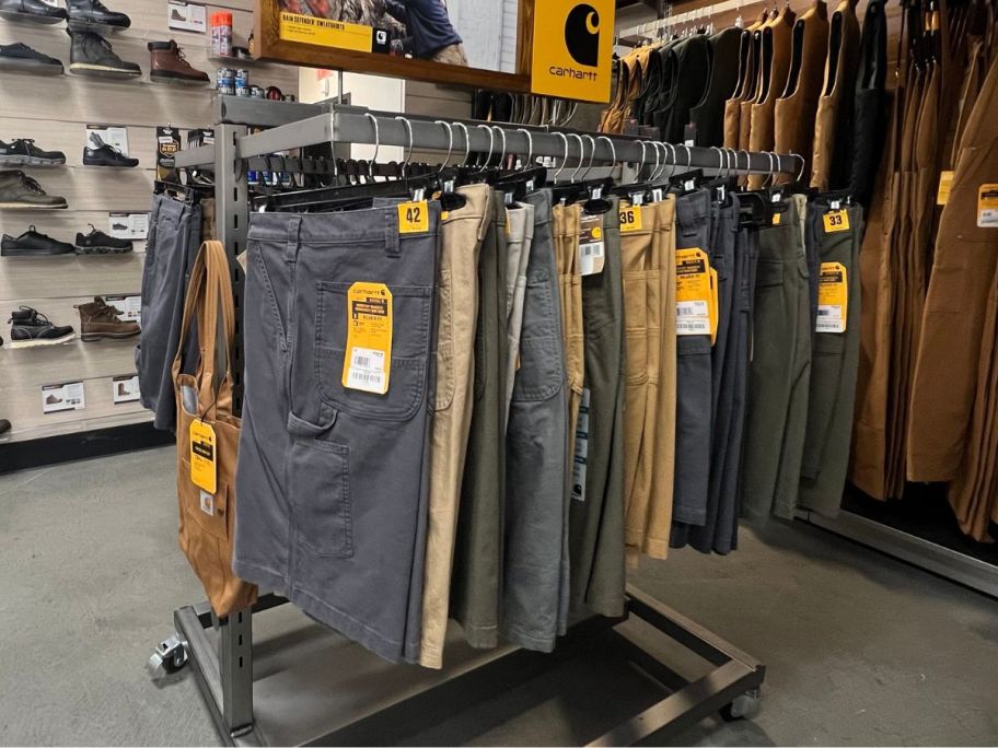 a rack of mens shorts in a carhartt store