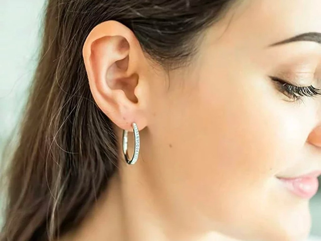 woman wearing diamond hoop earrings