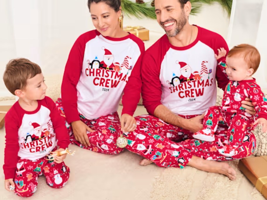 family wearing matching red and white Christmas pajamas that say 