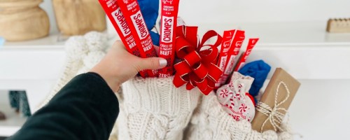 hand holding red chomps beef sticks in stocking