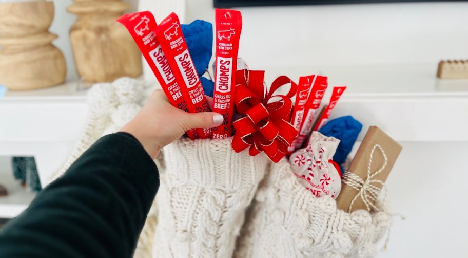 hand holding red chomps beef sticks in stocking