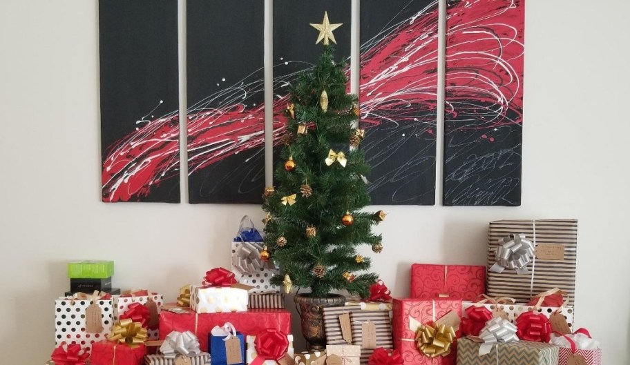 small christmas tree surrounded by gifts