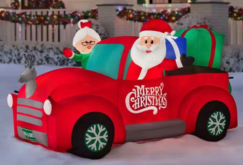 mr and mrs claus in inflatable truck