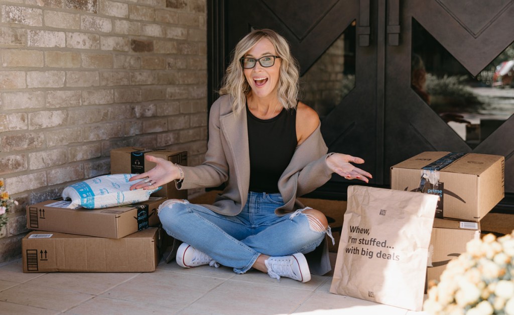woman sitting next to amazon packages