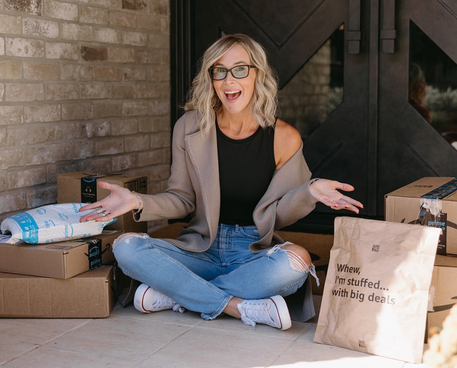 woman sitting next to amazon packages