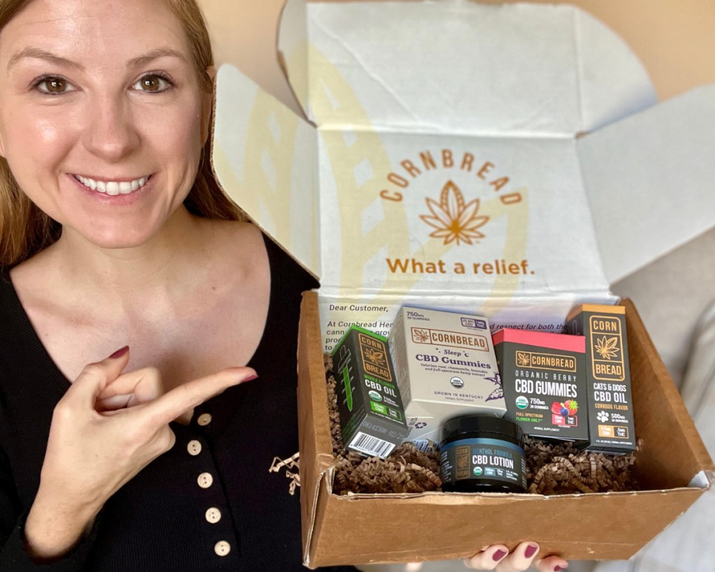 woman pointing at CBD products in box