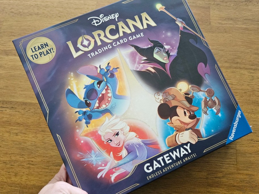 placing a boxed Disney Lorcana game on a table