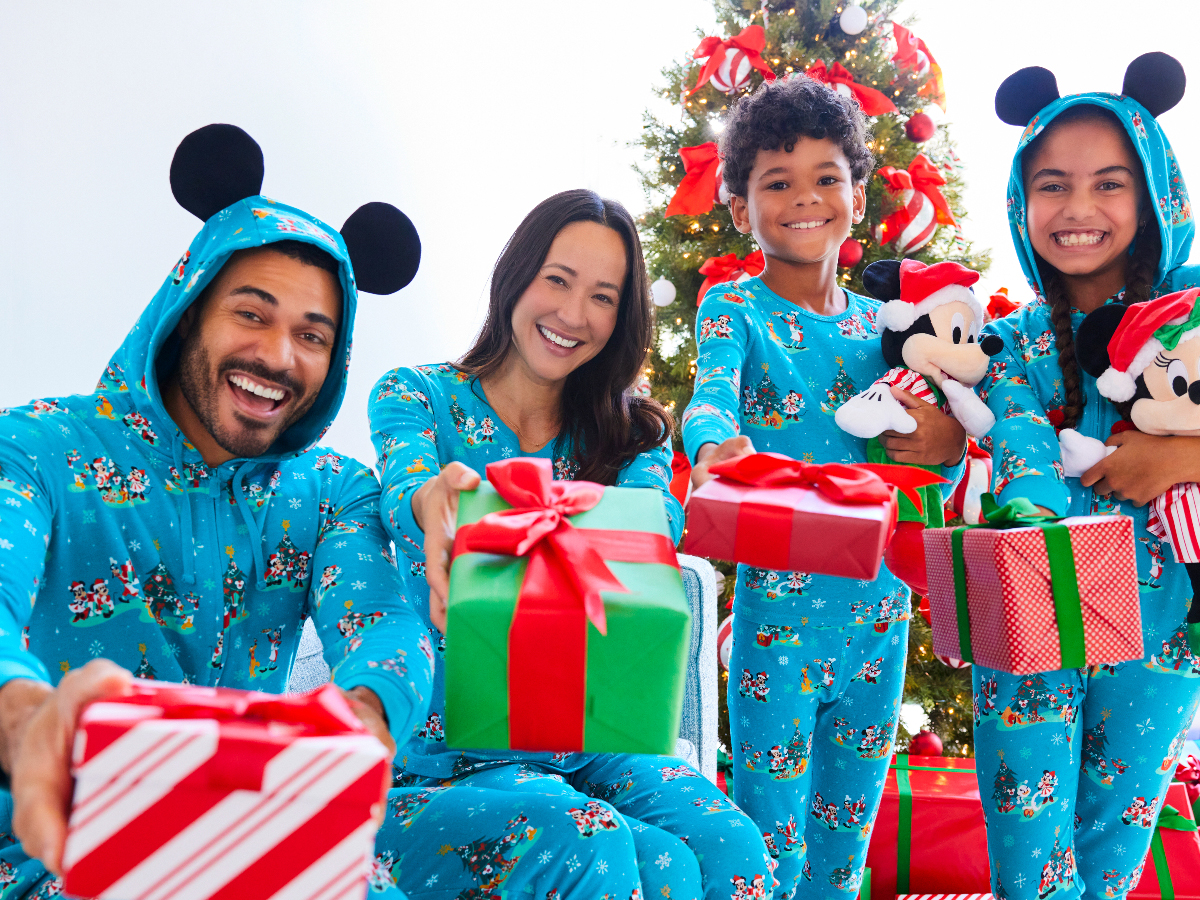 family wearing blue Disney matching pajamas with presents