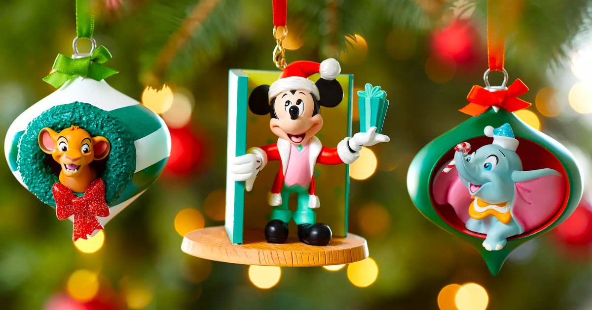3 disney sketchbook ornaments hanging on a christmas tree