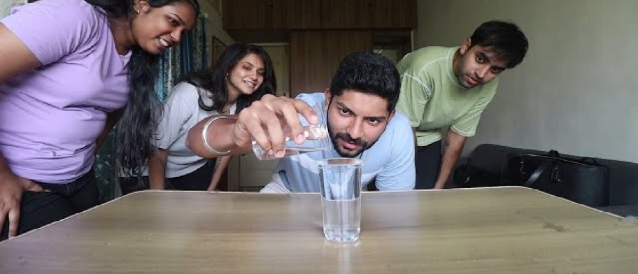 family pouring water into a glass during a holiday party game